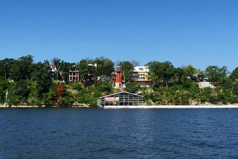 A view across Grand Lake of homes sitting high above the shoreline.