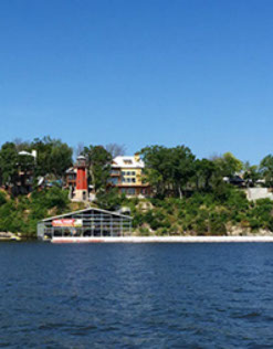 A view across Grand Lake of homes sitting high above the shoreline.